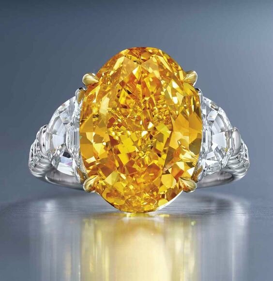 A rare 6.94 carats oval modified brilliant-cut fancy vivid