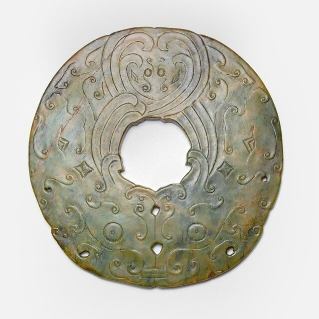 An archaistic dark green jade disc with phoenixes, Ming dynasty (1368-1644)