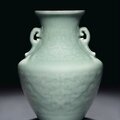 A rare celadon-glazed relief-decorated archaistic vase, qianlong six-character seal mark in underglaze blue and of the period 