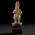 A rare small gilt-bronze standing figure, tang dynasty (ad 618-907)