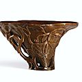 A carved rhinoceros horn ‘Lychee’ libation cup, Qing Dynasty , 17th-18th century