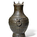 A rare archaic bronze wine vessel and cover, hu, warring states period