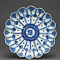 A blue and white moulded 'Lotus' dish, Wanli six-character mark in underglaze blue within a double circle and of the period (1573-1619)