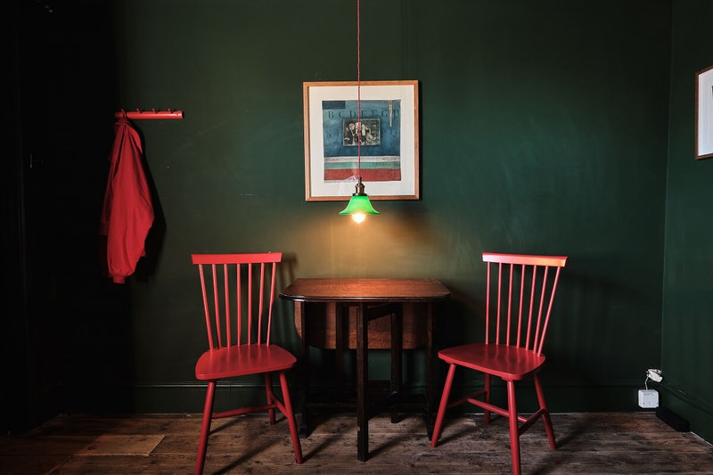moody-dark-green-sitting-room-red-chairs-nordroom