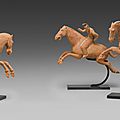 A very rare group of three red pottery figures of female polo players, Tang dynasty (AD 618-907)