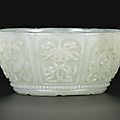 A pale celadon jade 'eight emblems' bowl, qing dynasty, qianlong period