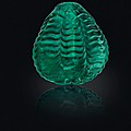 A carved emerald bead