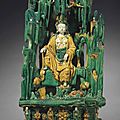 A large green, yellow and cream-glazed stoneware figure of the 'water-moon' guanyin in a grotto, ming dynasty, 16th century