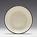 A small Dingyao molded saucer dish, Jin dynasty (1115-1234)