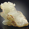 A small white and russet jade carving of a qilin, ming dynasty, 17th century