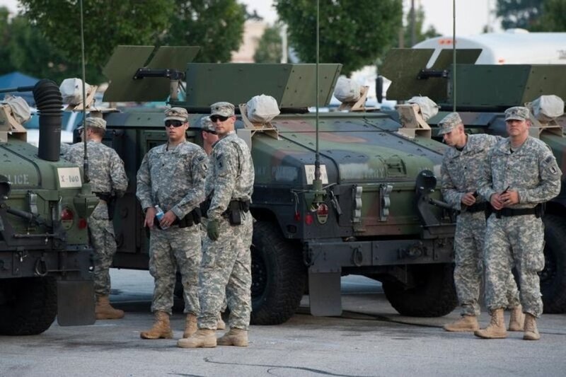 670767-national-guard-troops-arrive-at-a-mall-complex-that-serves-as-staging-for-the-police-in-ferguson